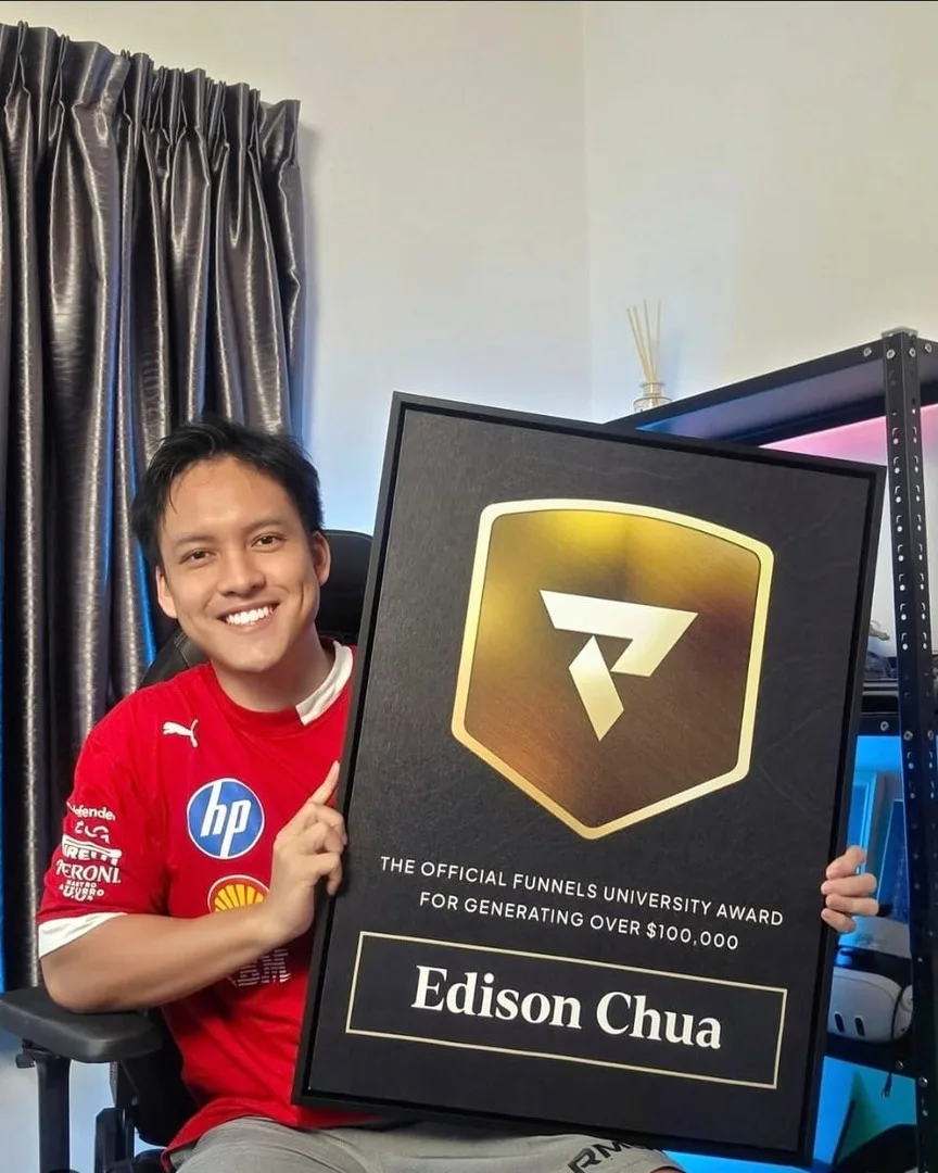 Edison holding the Funnels University award plaque.